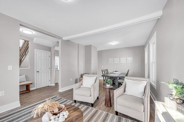 sitting room with hardwood / wood-style flooring and beamed ceiling