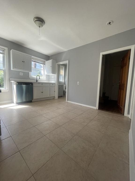 38 Chatham St, Lynn, MA 01902 - kitchen featuring dishwasher, light tile patterned flooring, white cabinets, and light countertops