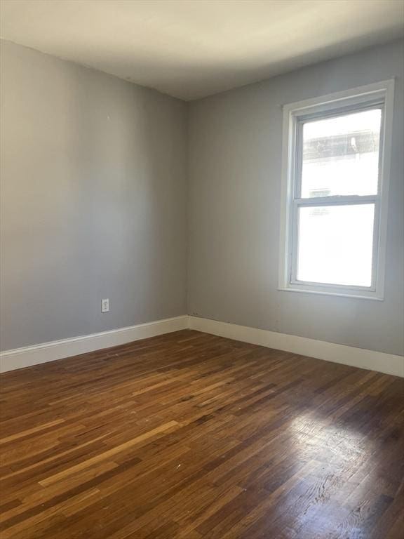 38 Chatham St, Lynn, MA 01902 - empty room with dark wood-style flooring and baseboards