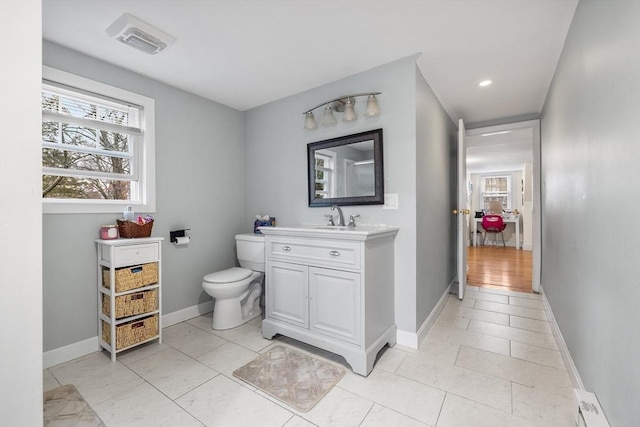 bathroom featuring tile patterned floors, baseboards, toilet, and vanity