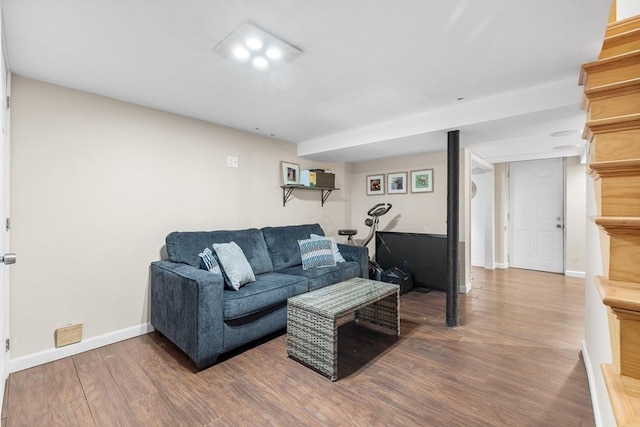 living area with baseboards and wood finished floors