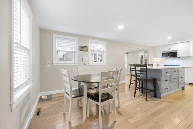 dining area with recessed lighting, light wood-style floors, visible vents, and baseboards