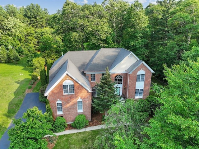 138 Fairview St, Holliston, MA 01746 - view of front of property with brick siding, a front yard, and a view of trees