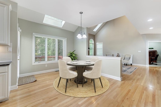 138 Fairview St, Holliston, MA 01746 - dining area with a skylight, a chandelier, light wood finished floors, vaulted ceiling, and recessed lighting