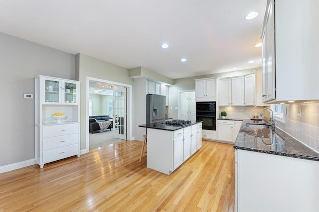 138 Fairview St, Holliston, MA 01746 - kitchen with black appliances, a center island, white cabinets, dark stone counters, and recessed lighting