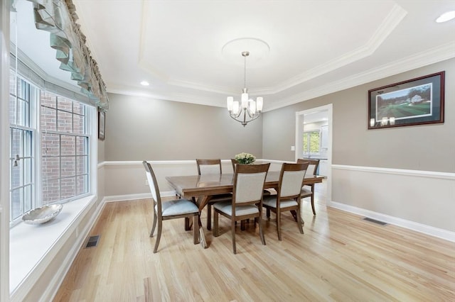 138 Fairview St, Holliston, MA 01746 - dining space with a tray ceiling, light wood-type flooring, a chandelier, and crown molding
