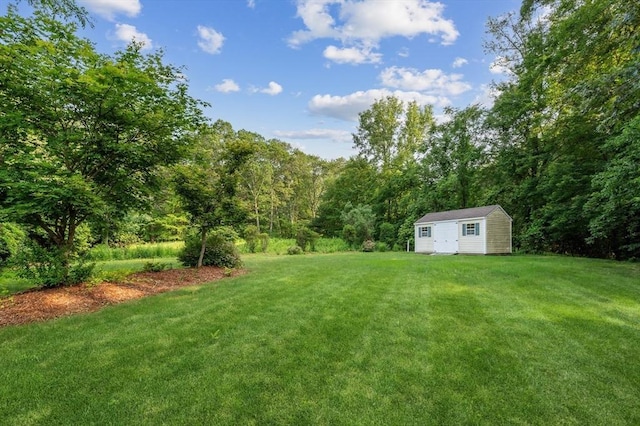138 Fairview St, Holliston, MA 01746 - view of grassy yard with a storage shed and a forest view