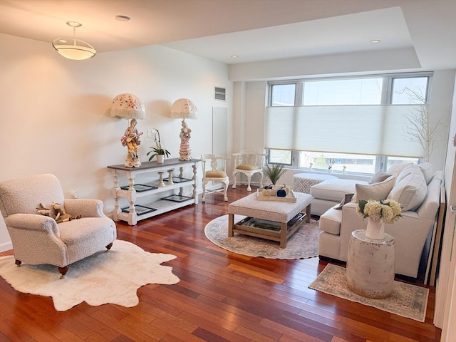living room featuring wood-type flooring and recessed lighting