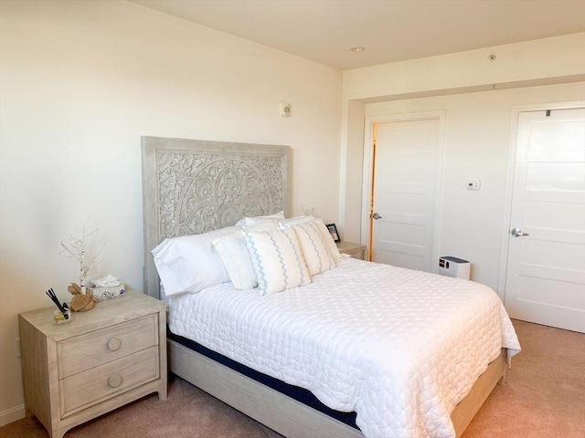 bedroom featuring light colored carpet