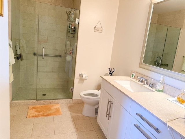 full bathroom featuring a shower stall, tile patterned flooring, toilet, and vanity