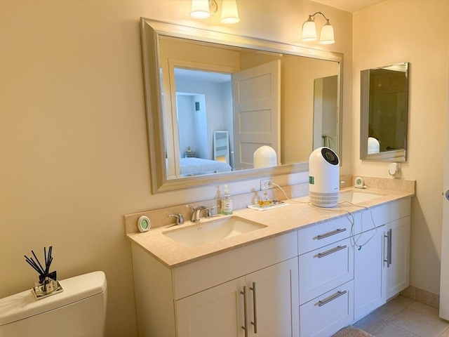 bathroom with double vanity, toilet, ensuite bath, and tile patterned flooring