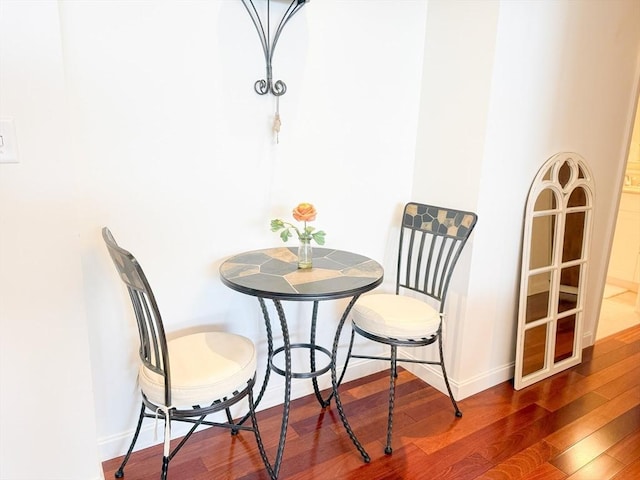 dining area with wood finished floors and baseboards
