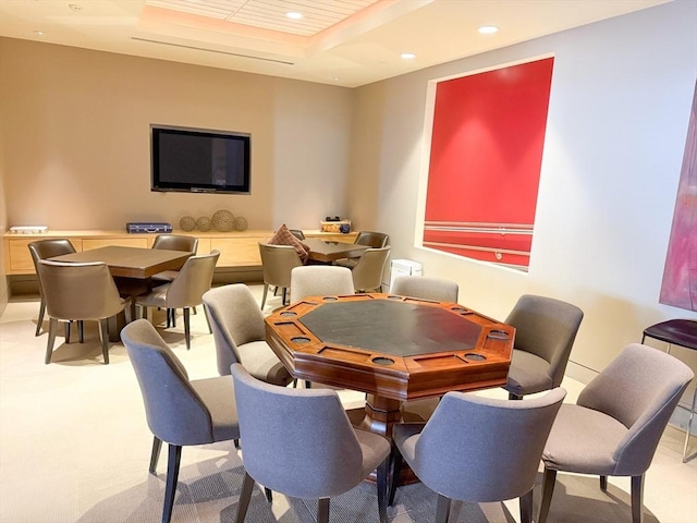 carpeted dining area featuring recessed lighting and a tray ceiling