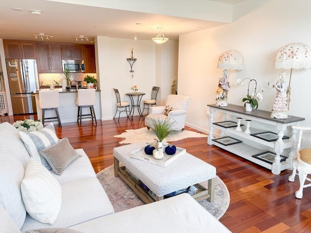 living area featuring wood finished floors and baseboards
