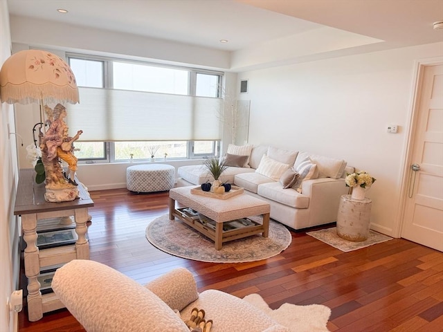 living room featuring hardwood / wood-style flooring, recessed lighting, and baseboards