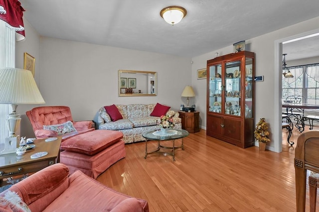 living room featuring light wood-type flooring and baseboards