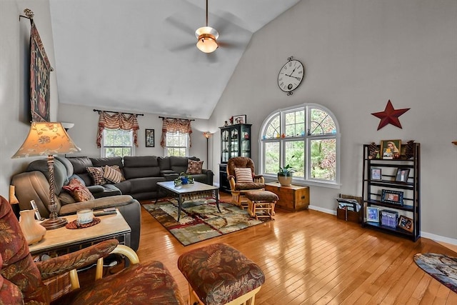 living area featuring hardwood / wood-style floors, high vaulted ceiling, and a healthy amount of sunlight