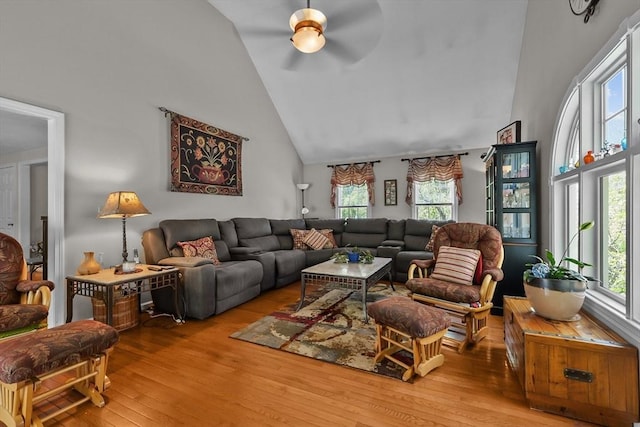 living area featuring ceiling fan, hardwood / wood-style floors, and high vaulted ceiling