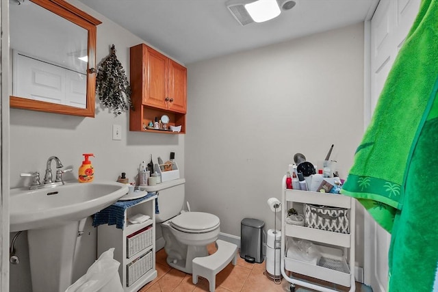 bathroom with tile patterned flooring and toilet
