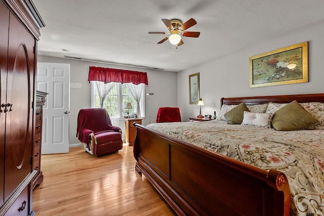 bedroom featuring light wood-type flooring, visible vents, and a ceiling fan