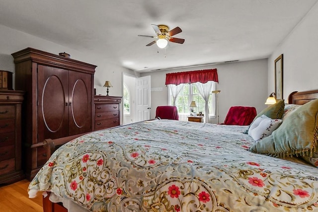 bedroom with light wood-style flooring and a ceiling fan