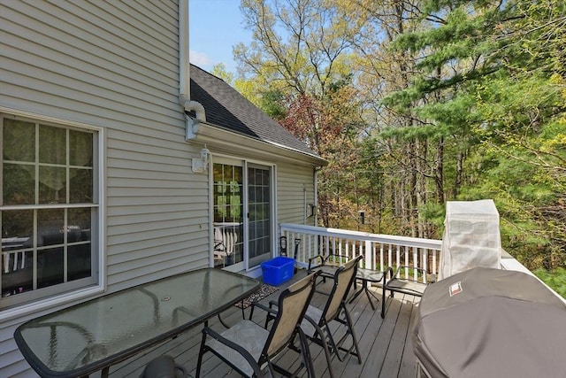 deck with grilling area and outdoor dining space