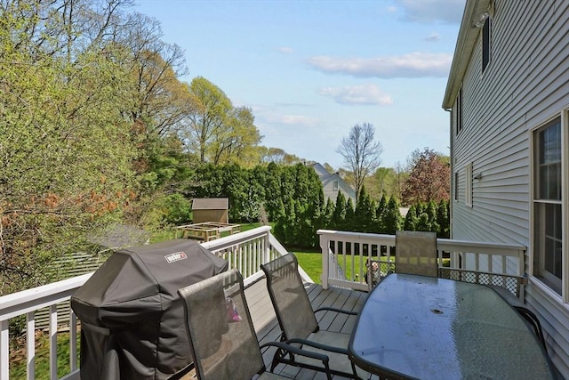deck with area for grilling and outdoor dining space