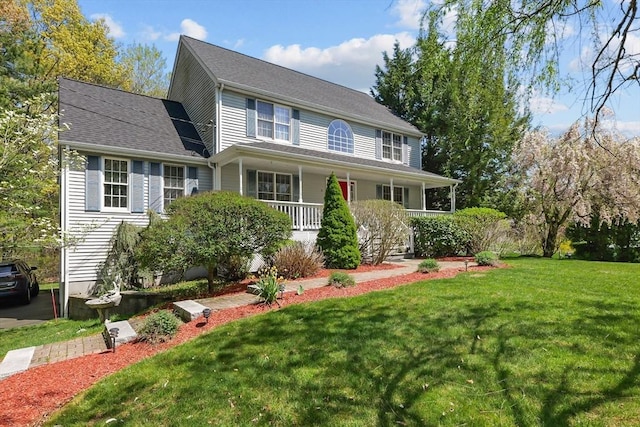 colonial house featuring a porch and a front lawn