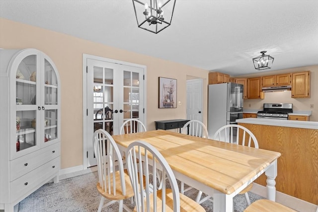 dining room with a notable chandelier and french doors