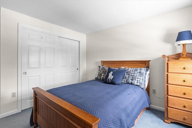 bedroom featuring carpet floors, a closet, and a textured ceiling