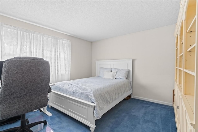 carpeted bedroom featuring a textured ceiling