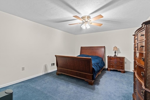 carpeted bedroom featuring ceiling fan and a textured ceiling