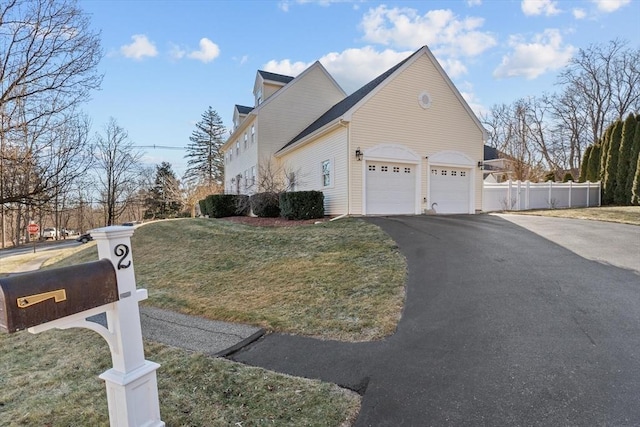 view of property exterior with a garage and a lawn