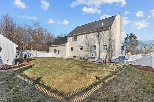 rear view of property featuring a yard