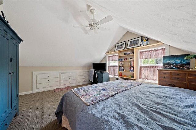 carpeted bedroom with a ceiling fan, baseboards, and vaulted ceiling