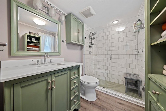 bathroom featuring vanity, toilet, a shower stall, and wood finished floors