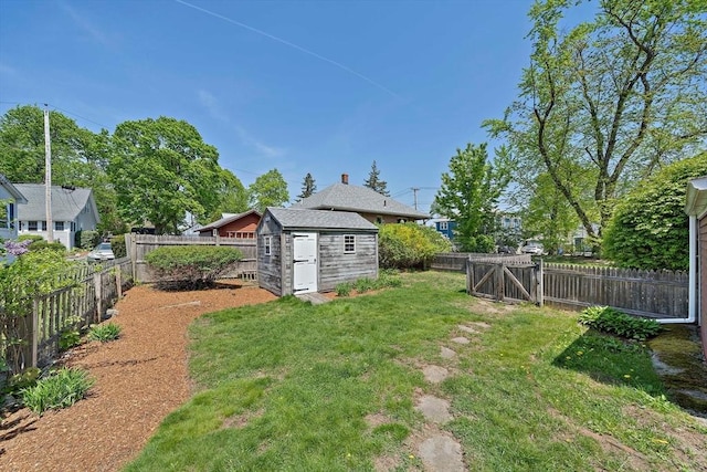 view of yard with a storage shed, an outbuilding, and a fenced backyard