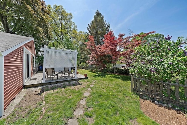 view of yard with a wooden deck and fence