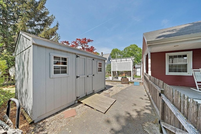 view of shed with a pergola and fence