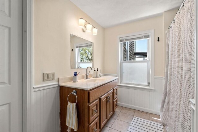 9-11 Dexter, Boston, MA 02127 - bathroom with a wainscoted wall, plenty of natural light, vanity, tile patterned flooring, and baseboards