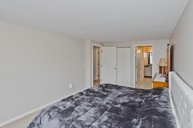 bedroom with a textured ceiling, a closet, and carpet