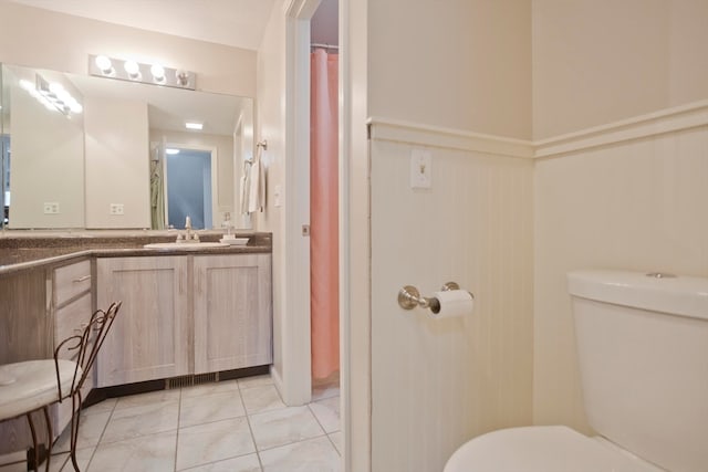 bathroom featuring vanity and toilet