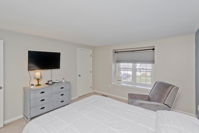 bedroom with light colored carpet