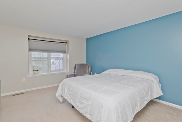 bedroom featuring light carpet