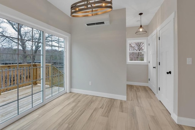260 Main St Unit 12, Blackstone, MA 01504 - unfurnished dining area with baseboards, light wood-style flooring, and a chandelier