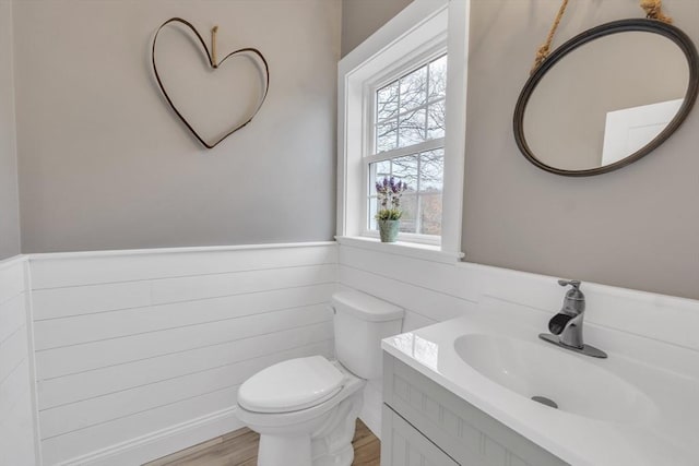 260 Main St Unit 12, Blackstone, MA 01504 - bathroom with a wainscoted wall, vanity, toilet, and wood finished floors