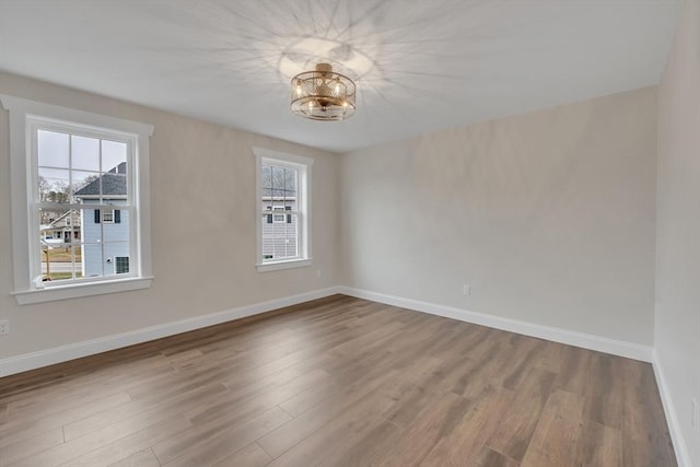 260 Main St Unit 12, Blackstone, MA 01504 - empty room featuring wood finished floors, baseboards, and a chandelier