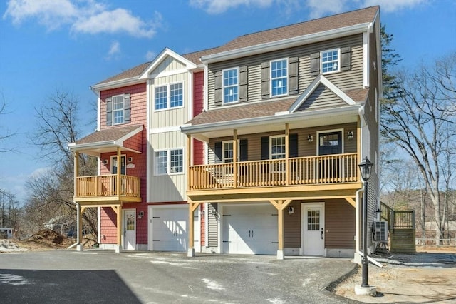 260 Main St Unit 12, Blackstone, MA 01504 - view of front of house featuring asphalt driveway, an attached garage, a shingled roof, board and batten siding, and a balcony