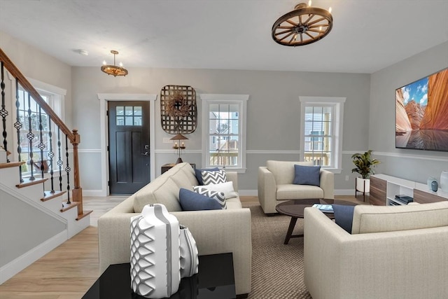 260 Main St Unit 12, Blackstone, MA 01504 - living room with a chandelier, stairs, baseboards, and light wood-type flooring