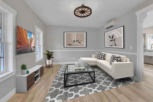 260 Main St Unit 12, Blackstone, MA 01504 - living room featuring a wall unit AC, wood finished floors, and baseboards